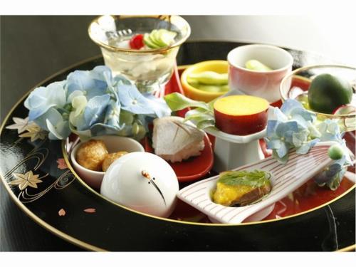 a table with a plate of food on a table at Hakone Fura in Hakone