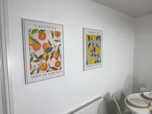 two posters on a wall in a bathroom at Long Stay Basildon Essex Business Contractors in Basildon