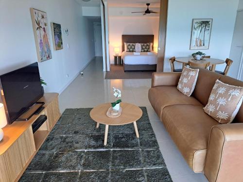a living room with a couch and a table at Oshen Holiday Apartments Yeppoon in Yeppoon