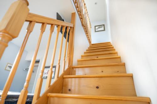 a staircase in a house with wooden steps at Glacier Creek Cabins in Seward