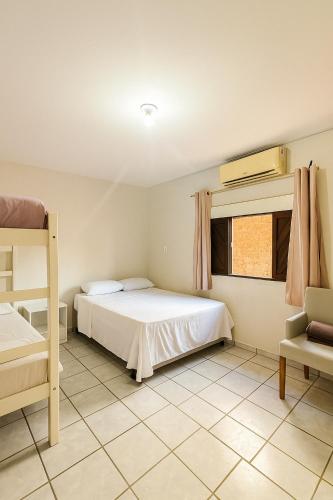 a bedroom with a bed and a bunk bed at pousada villa bella mar in Natal