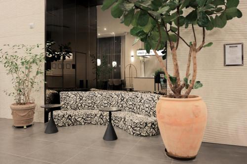 a large vase with a tree in a lobby at Aank Hotel Incheon Guwol in Incheon