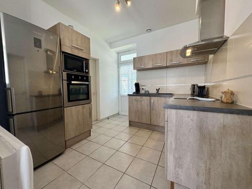 Il comprend une grande cuisine avec des appareils en acier inoxydable et du carrelage. dans l'établissement Maison calme Saint-Denis d'Oléron proche centre et plage - FR-1-246A-364, à Saint-Denis-dʼOléron