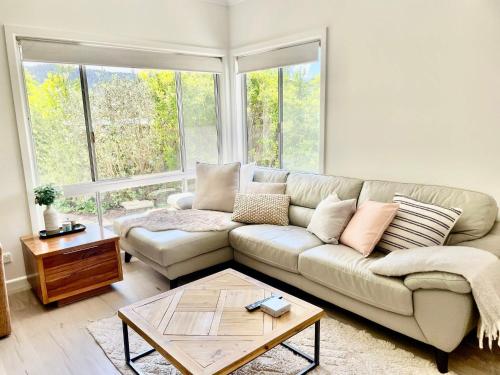 a living room with a couch and a coffee table at Clancy's Cottage -Talbingo in Talbingo