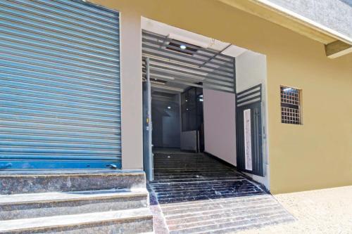 a hallway of a building with a garage door at Hotel O RBS Square Inn Uppal in Hyderabad