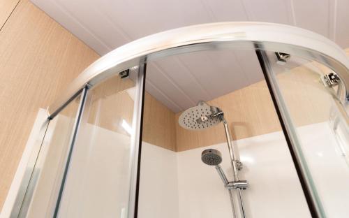 a shower with a shower head in a bathroom at Weka Pass Cottages 1 by Tiny Away in Waikari