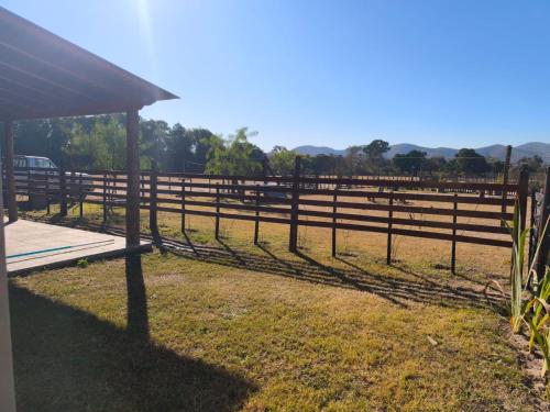 a wooden fence in front of a field at Cabañas El Alemán in Cerrillos