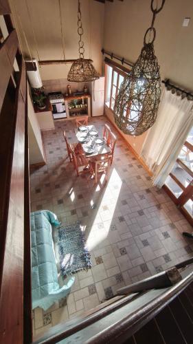 an overhead view of a living room with a table and chairs at Cabañas El Alemán in Cerrillos