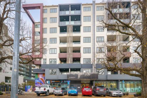 a building with cars parked in front of it at Convenient City Apartment in the Heart of Braddon - Hosted by Canstay in Braddon