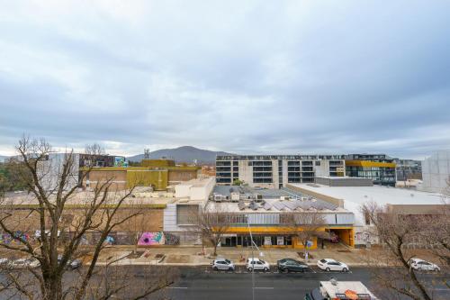 a city with a parking lot in front of a building at Convenient City Apartment in the Heart of Braddon - Hosted by Canstay in Braddon