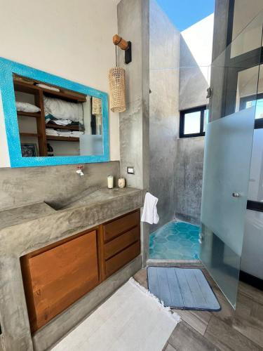 a bathroom with a shower and a sink and a mirror at Casa Mantra Ocean View & Private Terrace in La Ventana