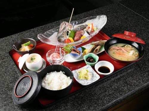 a tray of food on a table with rice at Hotel Verfort Hyuga in Hyuga
