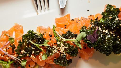 a plate of food with broccoli and carrots at Hotel Indigo Madrid - Gran Vía by IHG in Madrid