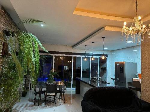 a living room with a kitchen and a dining room at Casa linda em Goianésia! in Goianésia