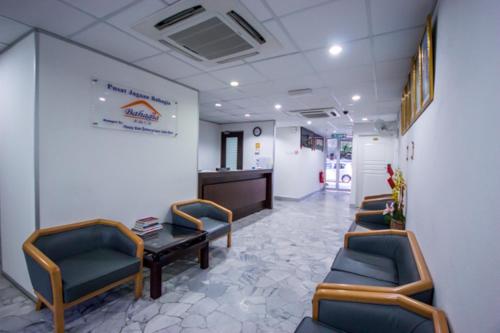 a waiting room with chairs and a table in a hospital at Bahagia Stay Georgetown in George Town