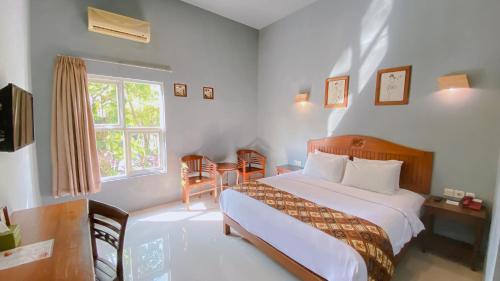 Postel nebo postele na pokoji v ubytování Bukit Daun Hotel & Resort