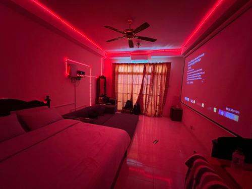 a room with a bed and a red light at KTC Suite Hotel with Private Cinema and PS5 in Gua Sai