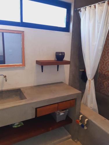 a bathroom with a tub and a window and a sink at Zen Studio Full Kitchen & Outdoor Chill Space in La Ventana