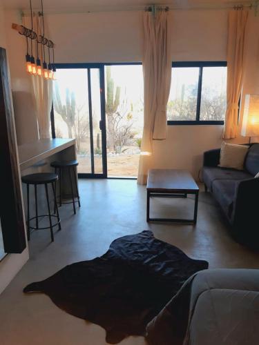 a living room with a couch and a table at Zen Studio Full Kitchen & Outdoor Chill Space in La Ventana