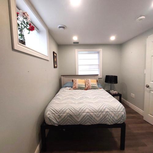 a bedroom with a bed in a room with a window at Modern,1BR Guesthouse Studio in Guelph