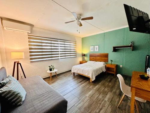 a living room with a bed and a couch at Espacio Libertad Colonia Americana in Guadalajara
