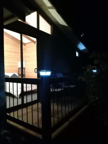 a night view of a balcony with a fence at Cabaña Tangara in San Gerardo de Dota