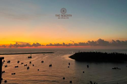 a group of boats in the water at sunset at The Rebirth Apartment Binh Chau Ho Tram in Ba Ria