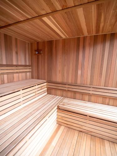 a large wooden sauna with wooden benches in a room at Tiny Homes & Sauna MIZUHO in Iiyama