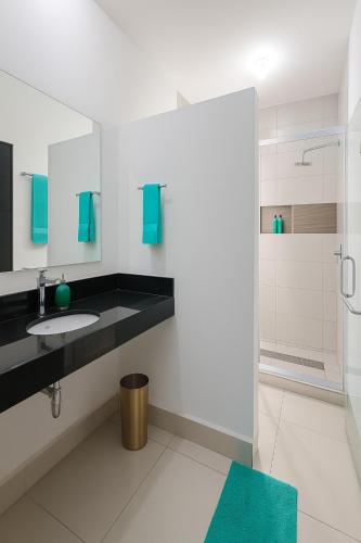 a bathroom with a sink and a shower at Mansion Cumbres Vista Panoramica Monterrey in Monterrey