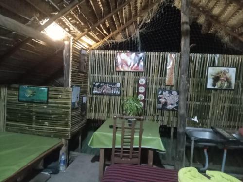 a room with a table and chairs in a hut at Ceylon Beach haven Uppuveli in Trincomalee