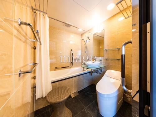 a bathroom with a toilet and a sink and a shower at APA Hotel Tottori Ekimae in Tottori