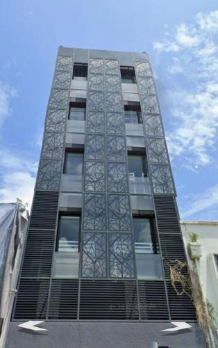 a tall building with black shutters on it at The Family Suites Serviced Apartments in Singapore