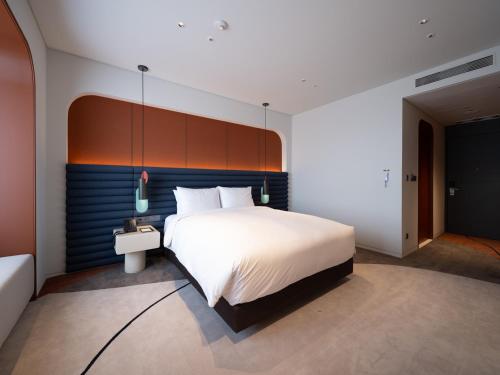 Postel nebo postele na pokoji v ubytování Enford Hotel Cheongju