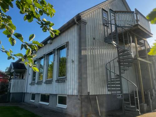 a metal house with stairs on the side of it at Kulla Skola in Veddige