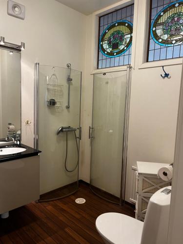 a bathroom with a shower and a sink and a window at Kulla Skola in Veddige