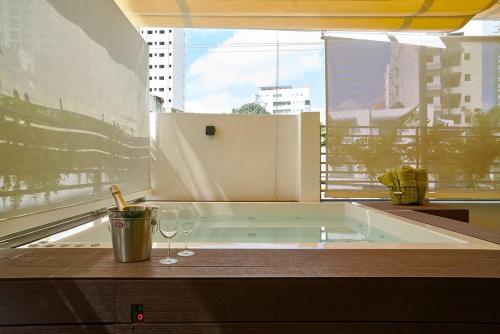 a bath tub in a room with a large window at ®{A~Tropical~Stay}@DowntownSD PrivéHotTubNetflix in Santo Domingo