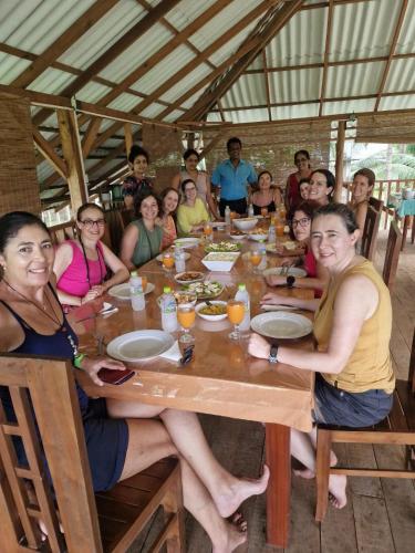 a group of people sitting around a table at Sigiriya Paradise Inn in Sigiriya