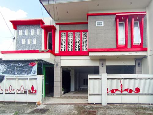 a house with red trim on the front of it at RedDoorz at Griya Jeniee Near Stadion Wilis Madiun in Madiun