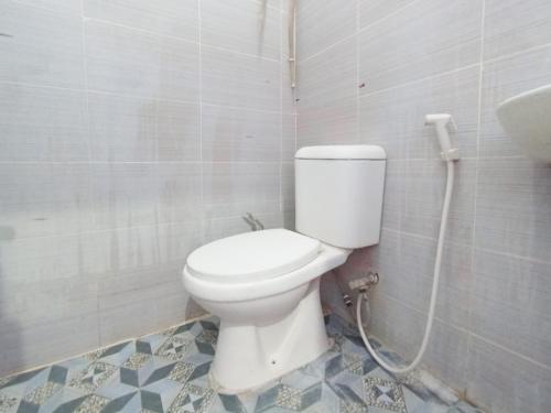 a bathroom with a white toilet in a room at RedDoorz at Griya Jeniee Near Stadion Wilis Madiun in Madiun