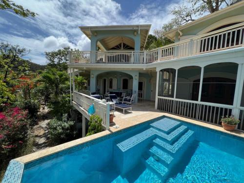 an image of a house with a swimming pool at Tropical Pool Villa with Big Views and Lush Gardens in Coral Bay