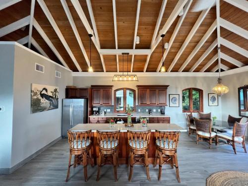 a kitchen with a large table and chairs at Tropical Pool Villa with Big Views and Lush Gardens in Coral Bay