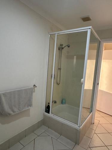 a shower with a glass enclosure in a bathroom at Sunset Guest Suite in Aldinga Beach