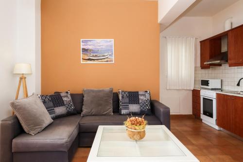 a living room with a couch and a table at Kiveri Gems Houses in Kivérion