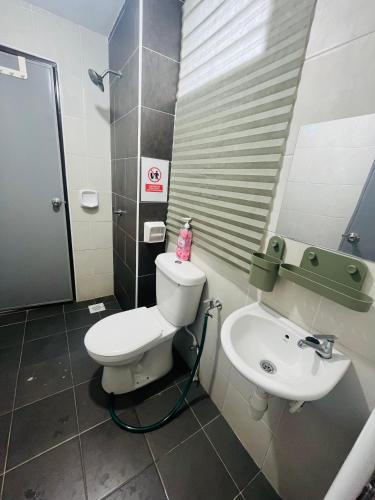 a bathroom with a toilet and a sink at Khasif Amani Homestay Parit Buntar in Parit Buntar