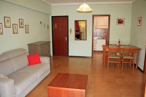 a living room with a couch and a table at Casa Orchidea Apartments in Torri del Benaco
