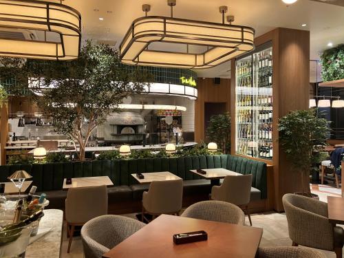 a restaurant with tables and chairs and a bar at lyf Shibuya Tokyo in Tokyo