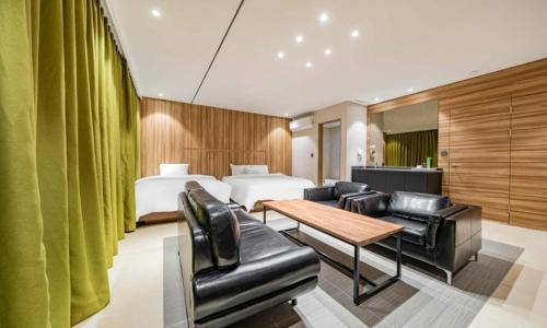 a hotel room with a bed and a table and chairs at Yeongdeungpo Lifestyle F Hotel in Seoul