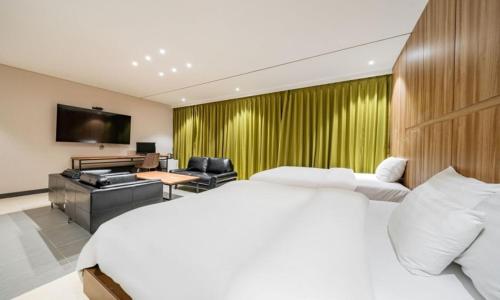 a hotel room with a large bed and a television at Yeongdeungpo Lifestyle F Hotel in Seoul