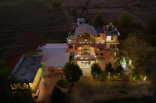 an aerial view of a large house at night at Yana's Farm in Māharjhari