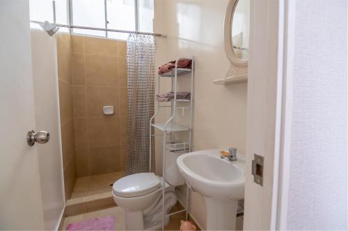 a bathroom with a toilet and a sink and a shower at Top Rated Apartment with Parking and Full Comfort in Tarapoto
